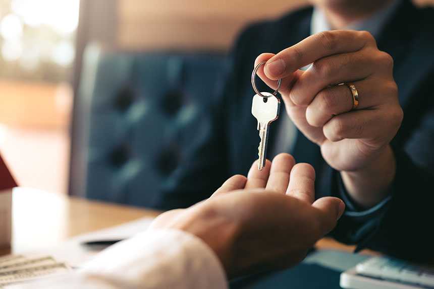 Realtor handing keys to buyer