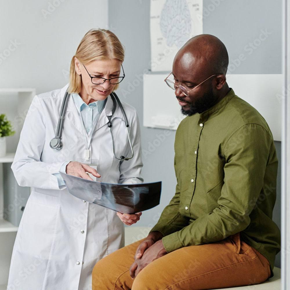 Doctor talking with a male patient about treatment and support