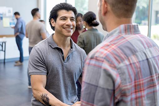 Two men shaking hands at a cancer support group