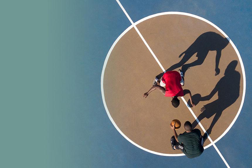 Two men playing basketball
