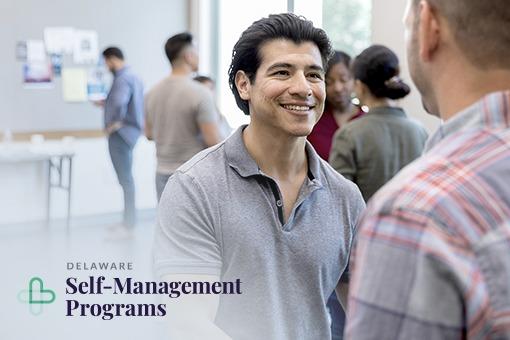 Two men shaking hands at a Diabetes self-management meeting