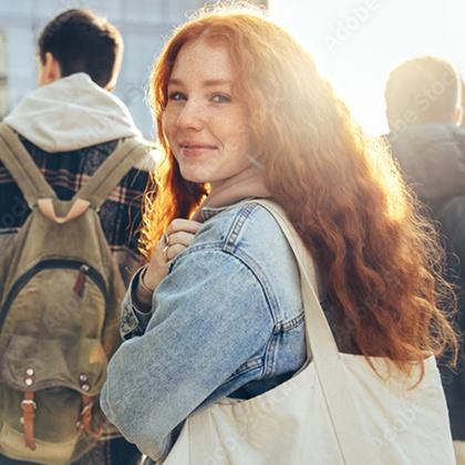 Teen holding a backpack