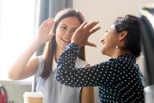 Woman giving a high five to her coach from the T2 Lifestyle Change Program