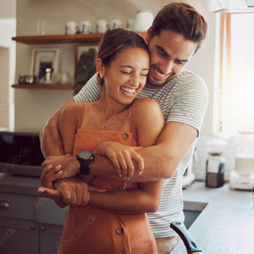 Couple embracing in their kitchen