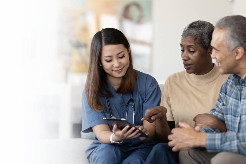 A couple discussing their options with a doctor at their health care visit