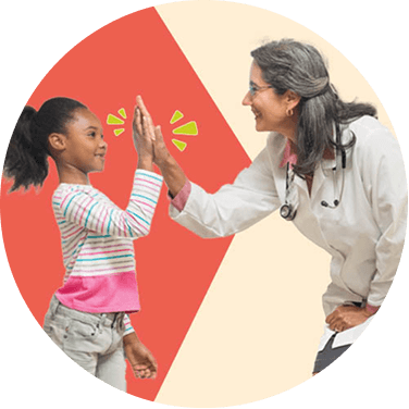 A doctor high-fiving a child patient