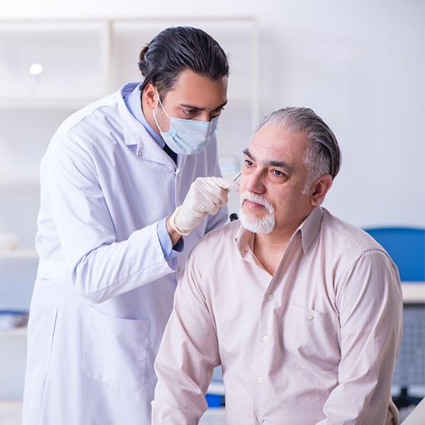 Doctor examining a male patient during a cancer screening