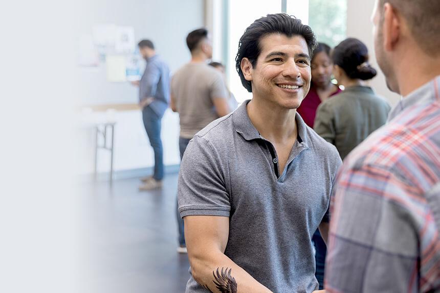 Two men shaking hands at a Diabetes self-management meeting
