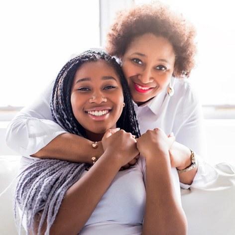 Mother and daughter smiling