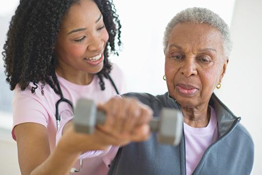 Patient exercising with support from a nurse