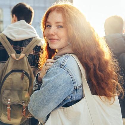 Teen holding a backpack