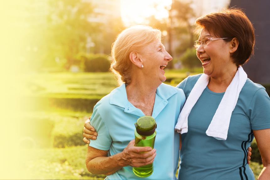 Two women laughing as they stay active to help prevent heart disease